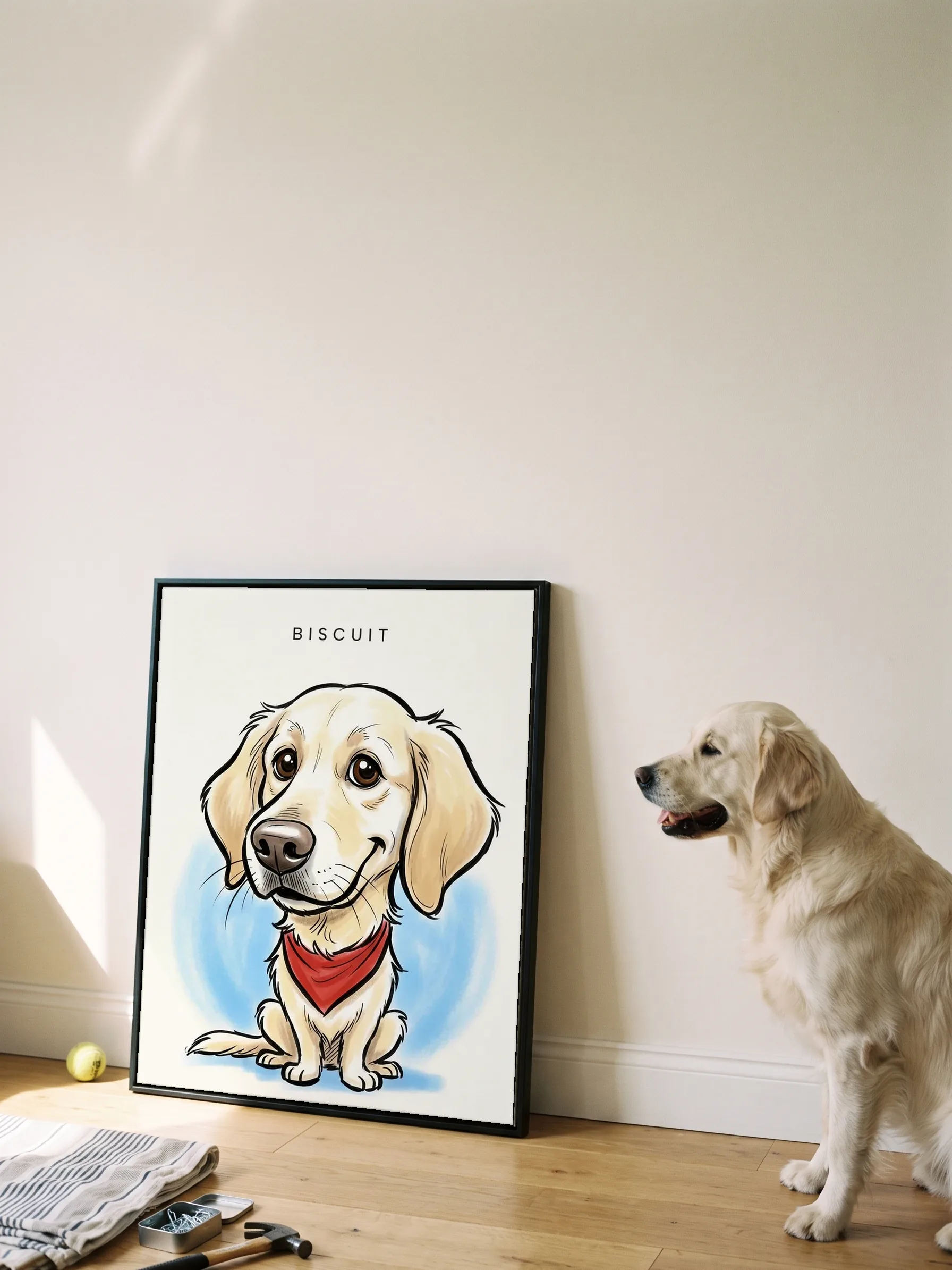 A golden retriever sitting in profile beside its own caricature: a canvas in a slim black frame leaning on a wall, sun on the floorboards