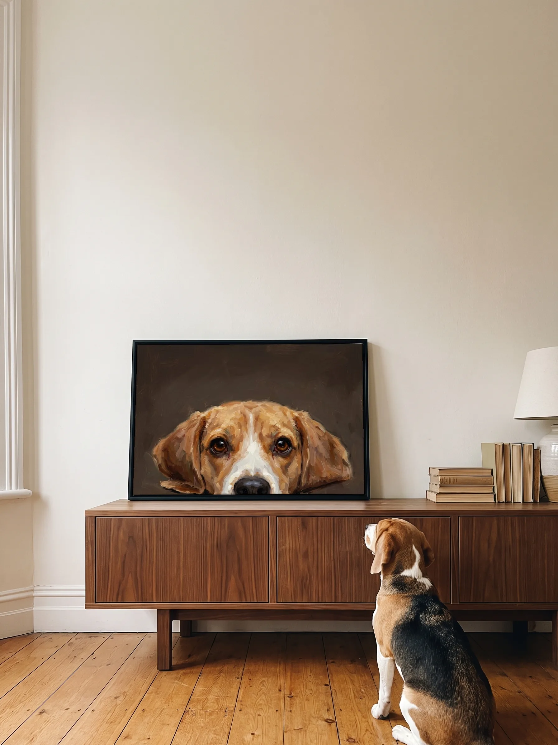 A beagle sitting on oak floorboards, seen from behind, looking up at its own oil portrait: a framed canvas on a walnut sideboard