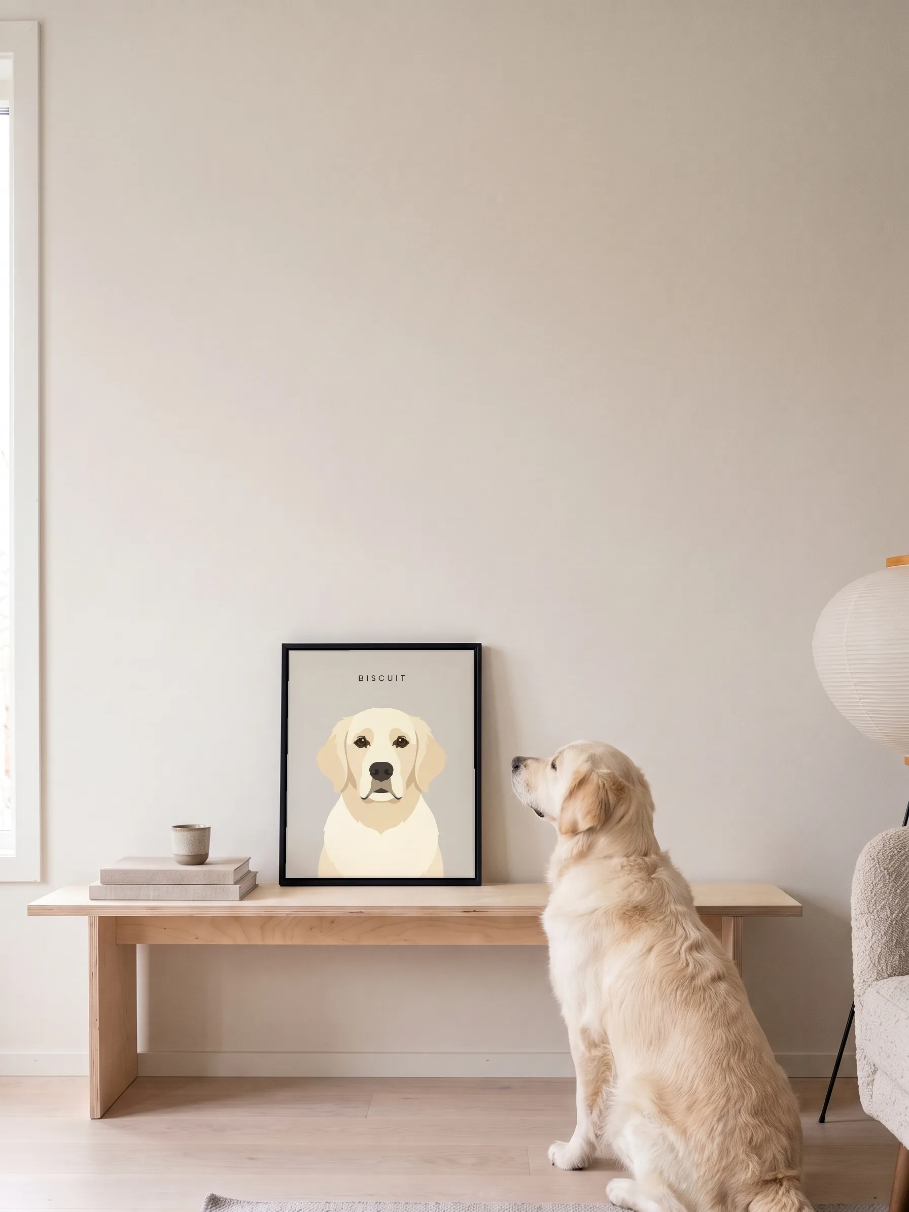 A golden retriever sitting on a pale wood floor, seen from behind, looking up at its own minimalist portrait: a framed canvas on a birch bench