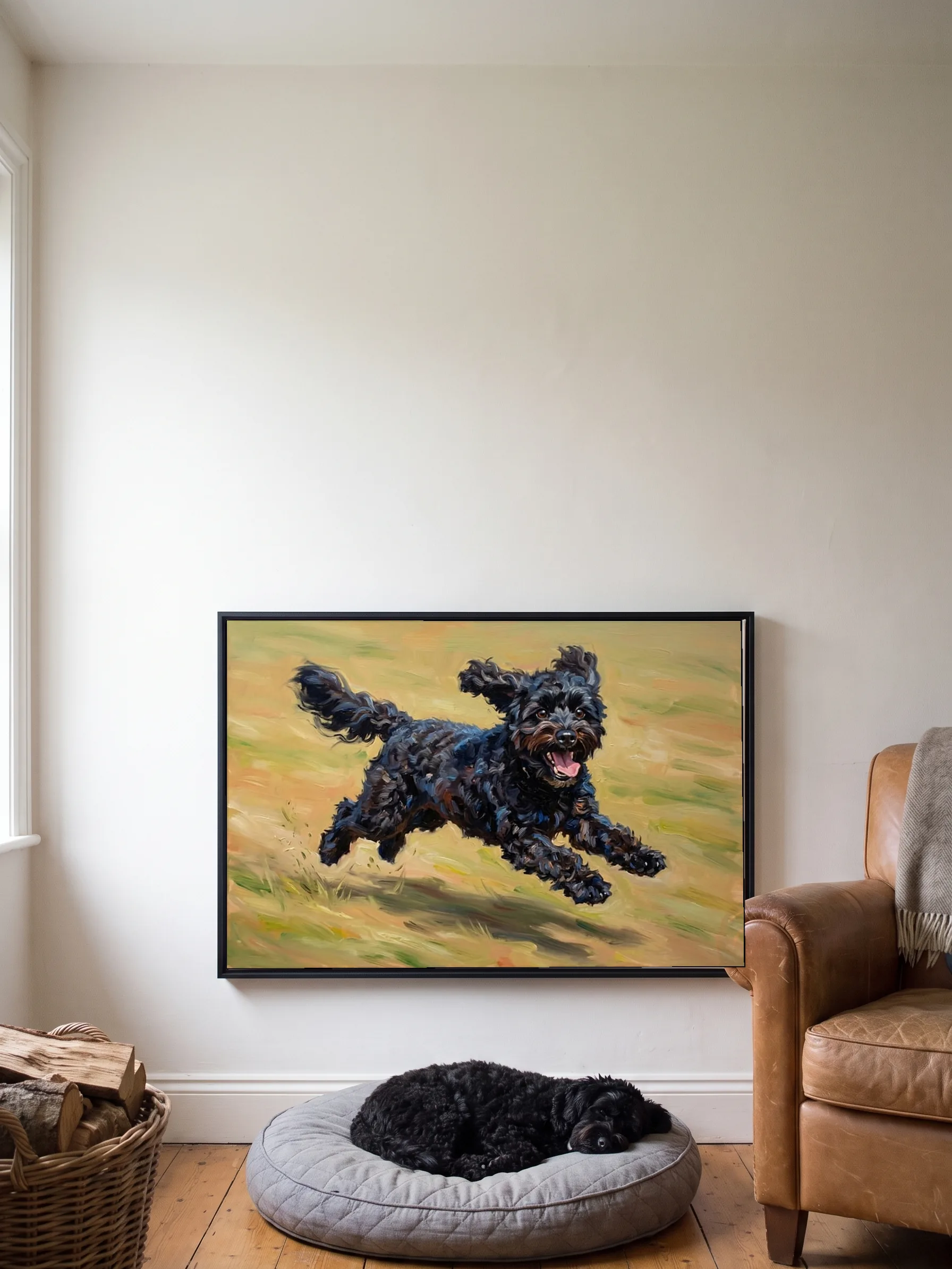 A small black curly-coated dog asleep in its bed under its own oil painting, a framed canvas on the wall